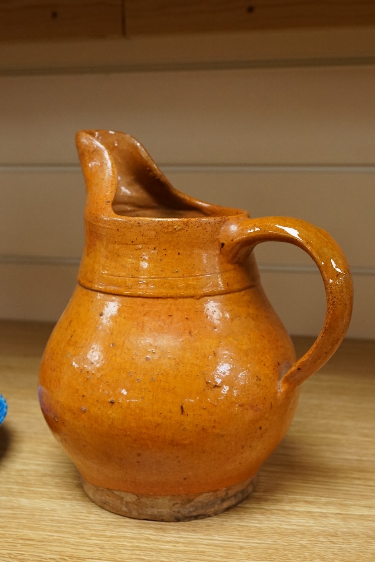 A Chinese blue glazed cylindrical brush pot, Kangxi mark but later, a similar saucer, Qianlong mark but later and a terracotta jug, 21cm